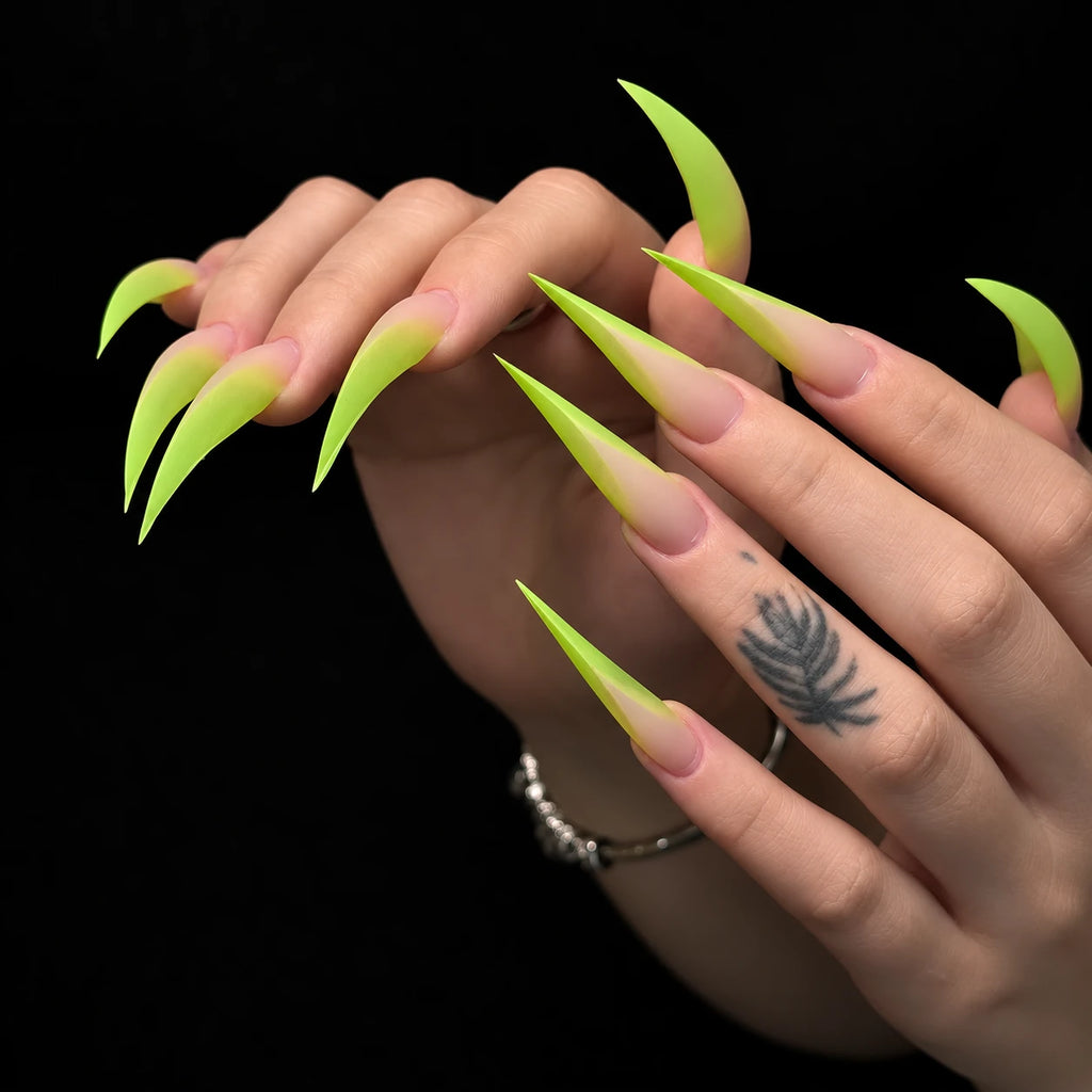 Extra long lime green ombre Dragon Claw press-on nails with nude pink bases and dramatic curved tips, displayed on both hands.