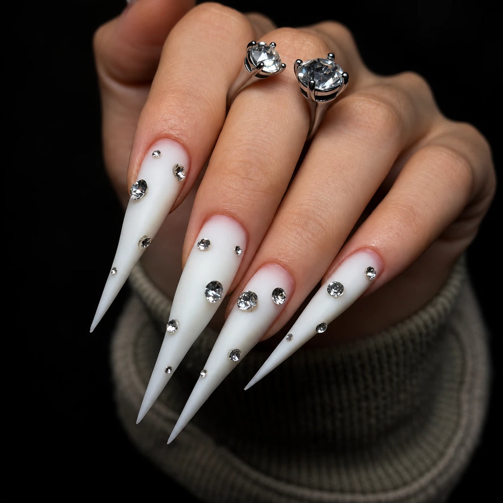 Side view of extra-long matte white Dragon Claw press-on nails decorated with sparkling rhinestones.